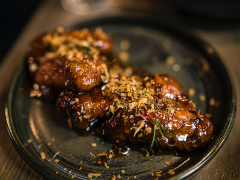 Glazed beef tenderloin on a plate.