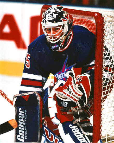 Dave Tucker keeps his eyes on the puck as he's backed into his net.