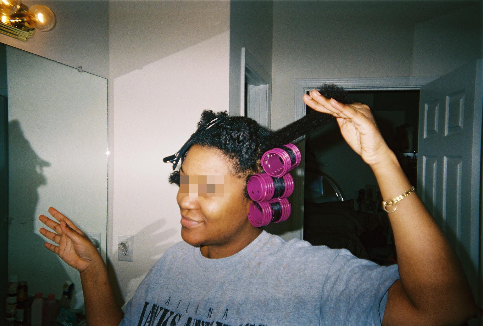 Length of hair is stretched out in preparation to roll