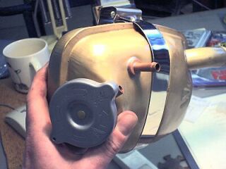No way would that pipe stay soldered in without a collar - cut from a little copper. Then off to the grit blaster. 