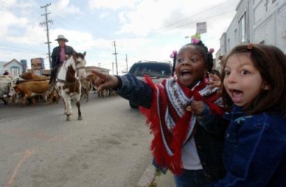 Ariel Knight, second from right, and an unidentified classmate, at right, area among 

a group of children from Bayshore Elementary School watching from the sidewalk as a 

cattle drive passes by in San Francisco, Thursday, Oct. 28, 2004. The cattle drive is 

being held in conjunction with the Grand National Rodeo, which is to take place at the 

Cow Palace in Daly City, Calif., which is to  begin Friday.  (AP Photo/Marcio Jose 

Sanchez)