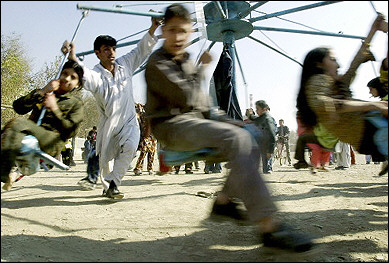 Cheap thrills : Afghan children spin around on a ride at a local playground in Kabul during the Eid Festival. (AFP/Farzana Wahidy)