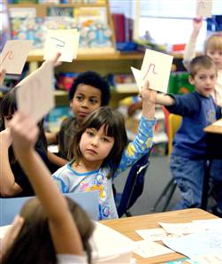 CHILDREN HOLD RUSSIAN LETTERS UP