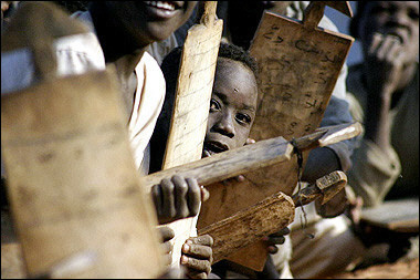 Sudanese displaced children attend a class at an outdoors makeshift school in Drage camp, on 

the outskirts of the southern Darfur town of Nyala, January 2005.  The Sudanese government 

reacted angrily to UN Security Council sanctions over atrocities in Darfur, but the rebels argued the 

move against Khartoum is too timid to yield a breakthrough in the conflict.(AFP/File/Jose Cendon)