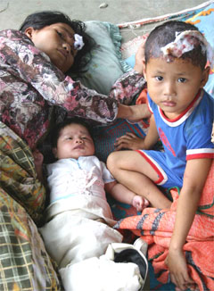 A mother and her two children get some rest at a temporary shelter after their house is 

damaged by earthquake in Nias island, Indonesia, Tuesday. (AP/Buyung Tjendra)