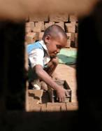 A seven-year-old Indian girl, Rameshwari, works in a brick kiln on the outskirts of the northern Indian city of Jammu, April 22, 2005. India's constitution bans children younger than 14 from working but human rights group estimate up to 115 million children, roughly twice the entire population of Britain, work for a living. REUTERS/Amit Gupta