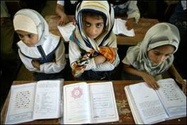 Girls sit at their desks at a school in Baghdad. More girls in countries around the world are going to school, though the gender gap in many regions remains wide, according to a new report by the United Nations' Children's Fund (UNICEF)(AFP/File/Karim Sahib)