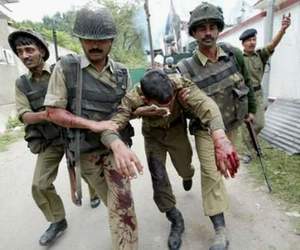 Border Security Force troopers help an injured colleague after they stormed a building in Srinagar, the summer capital of Jammu and Kashmir state