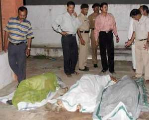 The bodies of Hindu pilgrims are laid on the ground in the city of Gandhinagar, India, capital of the western state of Gujarat, on Sept. 24, 2002.