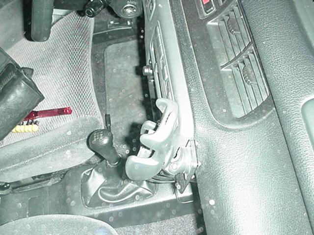 Photo: Bracket sticking out from under bezel, viewed from above, Honda Civic (92 93 94 95)