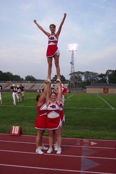 Jerrica, Emily, Jenny, & Courtney warm up their single based extension before the varsity scrimmage! Awesome ladies!