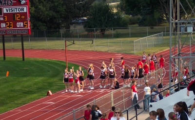All the fall cheerleaders wait for their turn on the field to perform.