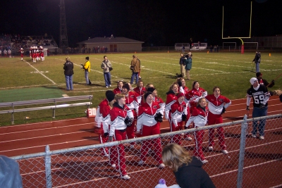 The Varsity football squad charge the crowd!