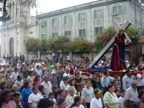 Crowds follow a group carrying a statue of Jesus for religious reasons, Granada.