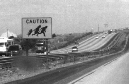 What's up with this one?  Beware evil parents who drag their children across highways?  Beware illegal aliens fleeing Mexico?  Odd. 