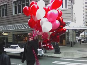 I saw this man walking out of a flower shop in downtown Seattle.  I thought it was a good image for the day.  Photo taken on February 14, 2007.