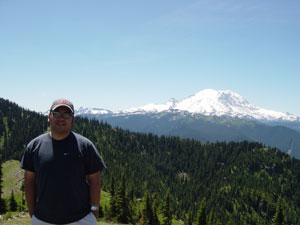 Photo of Nick Peyton and Mount Rainer on top Noble Knob on July 9, 2006.  Photo courtesy of Nick Peyton.