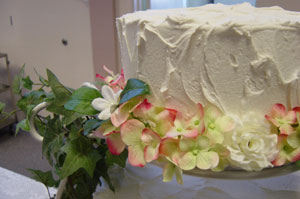 A photo of Lindsey and Max's wedding cake. You know I have no idea what flavor it was, I had a piece from the back up sheet cakes.  Photo by Nick Peyton, taken August 8, 2006.