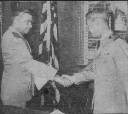 Rear Adm. Jeane R. Clark (left), shakes hands with Capt. Donald F. McLean following their change of command ceremony.  This picture was taken from the July 2, 1954 issue of 'The Hoist.'