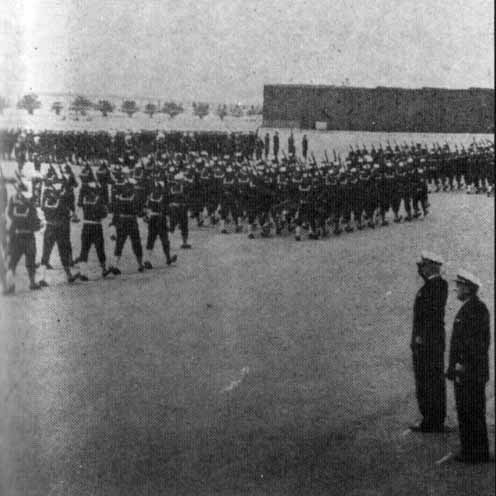 Capt. Joseph A. Connolly (second from right) reviews recruits graduating on June 30, 1951 immediately following his retirement ceremony and the change of command ceremony with Capt. Frank Monreoe.
