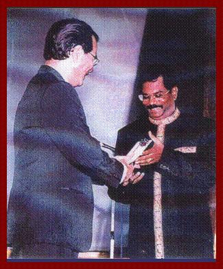 Mr M S Maniam receiving his award and prize from the hands of COMPASS Chairman, Mr Chang Kwai Ming.