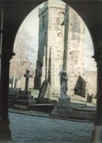 sunlit tower of old church seen from new church doorway