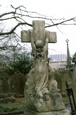 child clinging to cross