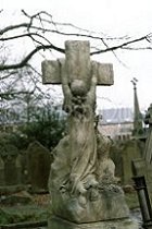 child clinging to cross
