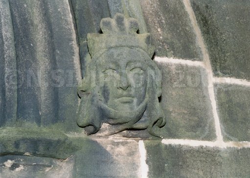 carved stone head on wall