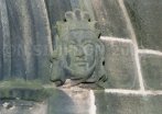 carved head on wall