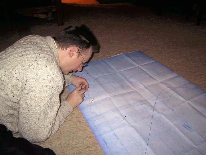 Piercing through the blueprints to mark the wood with pins, then join the dots!