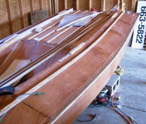 Treated skirt strips are glued and screwed into place