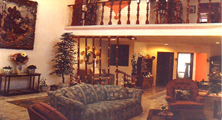 THIS VIEW SHOWS THE LIVINGROOM AND THE HALL BALCONY