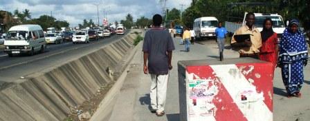 vehicles behind pedestrian barrier