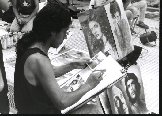 Street artist drawing, Florida street, portraits exposed: Jacqueline Bisset, Charly Garcia, Ernesto Che Guevara and jorge Luis Borges