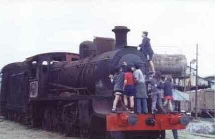 Children exploring an old locomotive, C.F. Lynch station