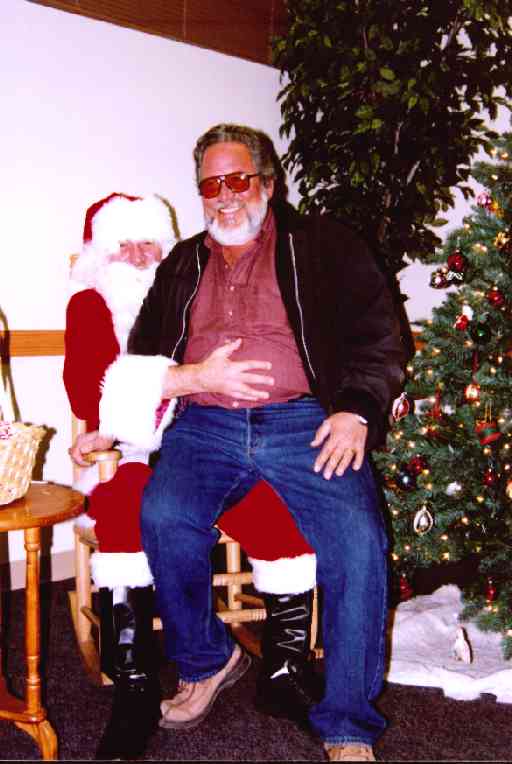 Jim Montalvo '65 sitting on Santa's lap (Warren Miller '66)