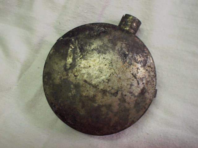 Artifact tin gunpowder flask, enscribed '1832.'
Credit: Butch Baker Collection. 
(Image used with permission of the owner; all rights reserved.)