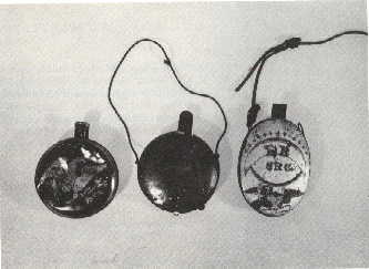 Described as 'canteens' by Curtis and Guthman, 
these artifacts are actually two different styles 
of tin gunpowder flasks.