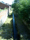 On one side of the bridge the beck is man-made