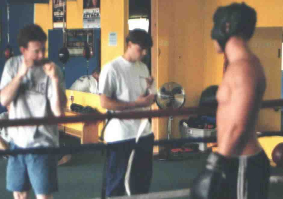 Boxer gets some mid-round pointers from the trainer.&nbsp; Photograph copyright 1999.&nbsp; All rights reserved.