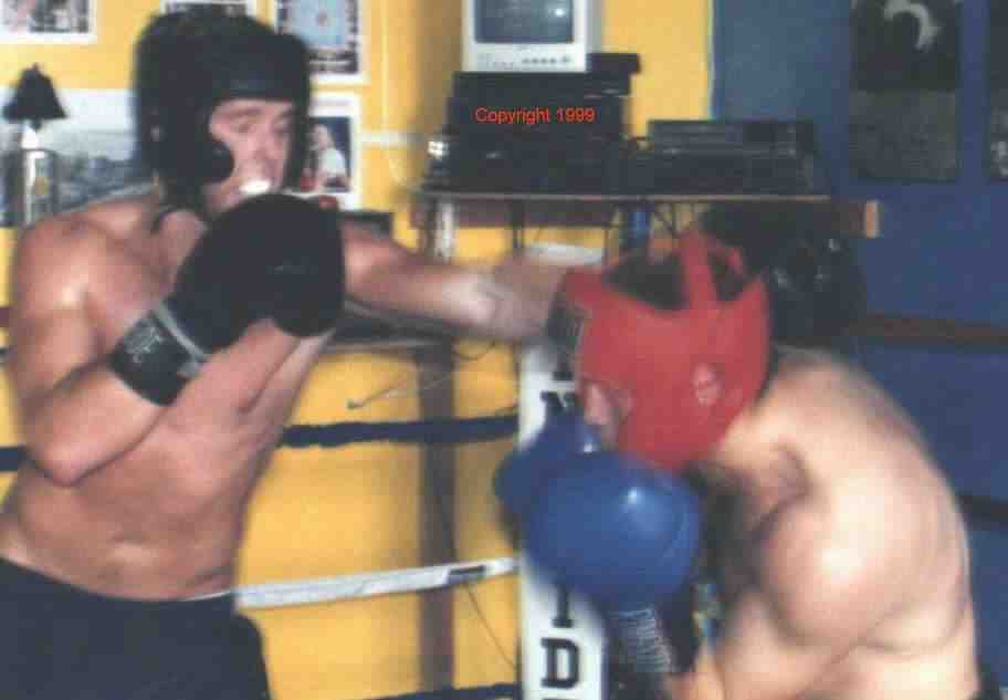 Ducking under the jab.&nbsp; Sparring is a way to apply what you learned in the drills.&nbsp; Photo copyright 1999.&nbsp; All rights reserved.