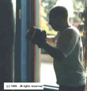 Proper equipment, such as handwraps and quality bag gloves, are essential to a safe and efficient workout.&nbsp; Image copyright 1999.&nbsp; All rights reserved.