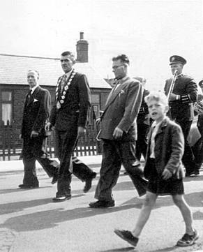 Parade past Ruby's Fish Shop, c.1955