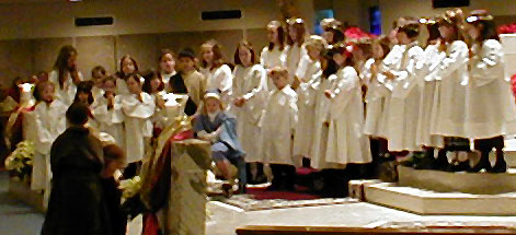 Angels sing and gather about Mary Joseph and child