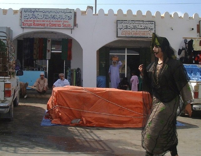 A Bedu woman strolls on by (an example of sneaking a photo using a digital camera).