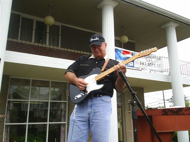 Phil playing away on his guitar.