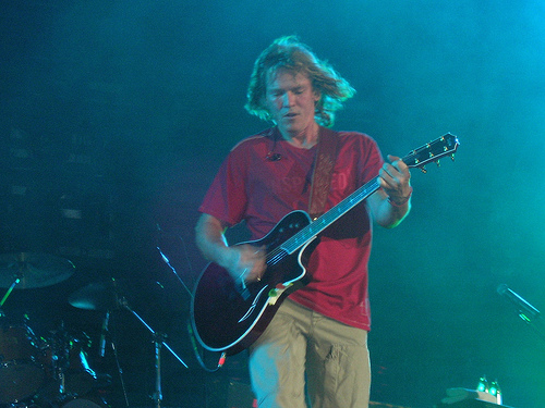 Rocko, from Rocko and the Devils, wearing the red INSPI(RED) shirt.