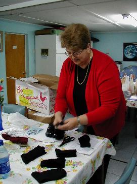 Cecilia sorting shoes donated by St. Joseph's parish for children in the poblaci�n.