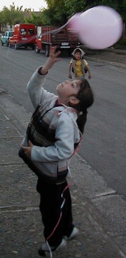 Connie playing with a balloon outside.